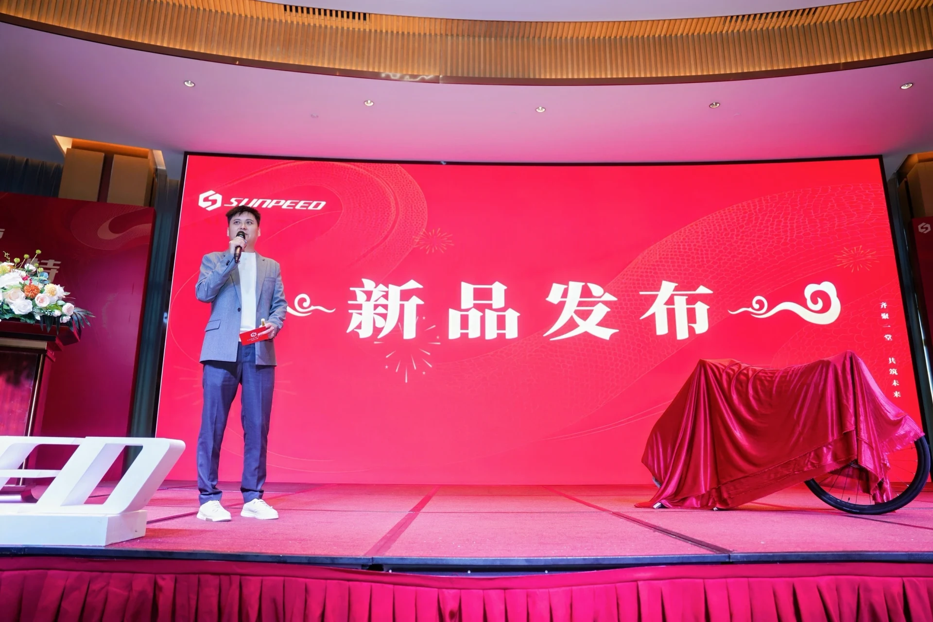新品发布舞台上的演讲者与展品